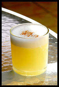 A photo of a Pisco Sour cocktail.